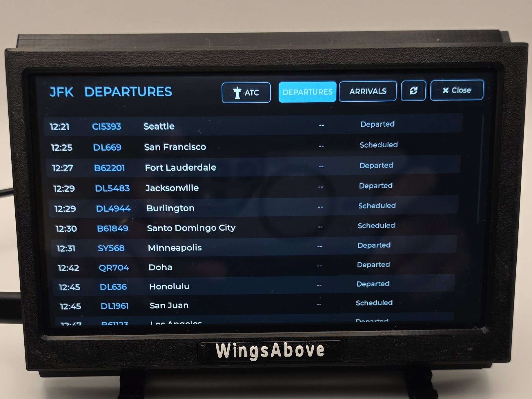 JFK departures board with live times and statuses, plus an ATC tab